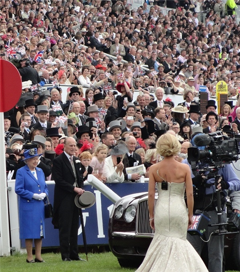 Image: The Queen and Prince Philip facing singer Welsh singer Katherine Jenkins with large crowd looking on