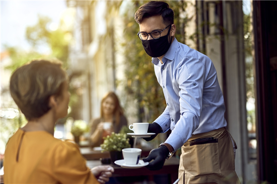 Image: Coffee shop reopen outside server wearing facemask